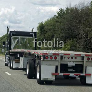 empty flatbed driving freeway