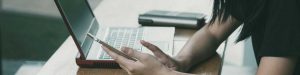 young person on cell phone and laptop